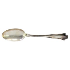 Silver rice and serving spoon with a long, scalloped handle