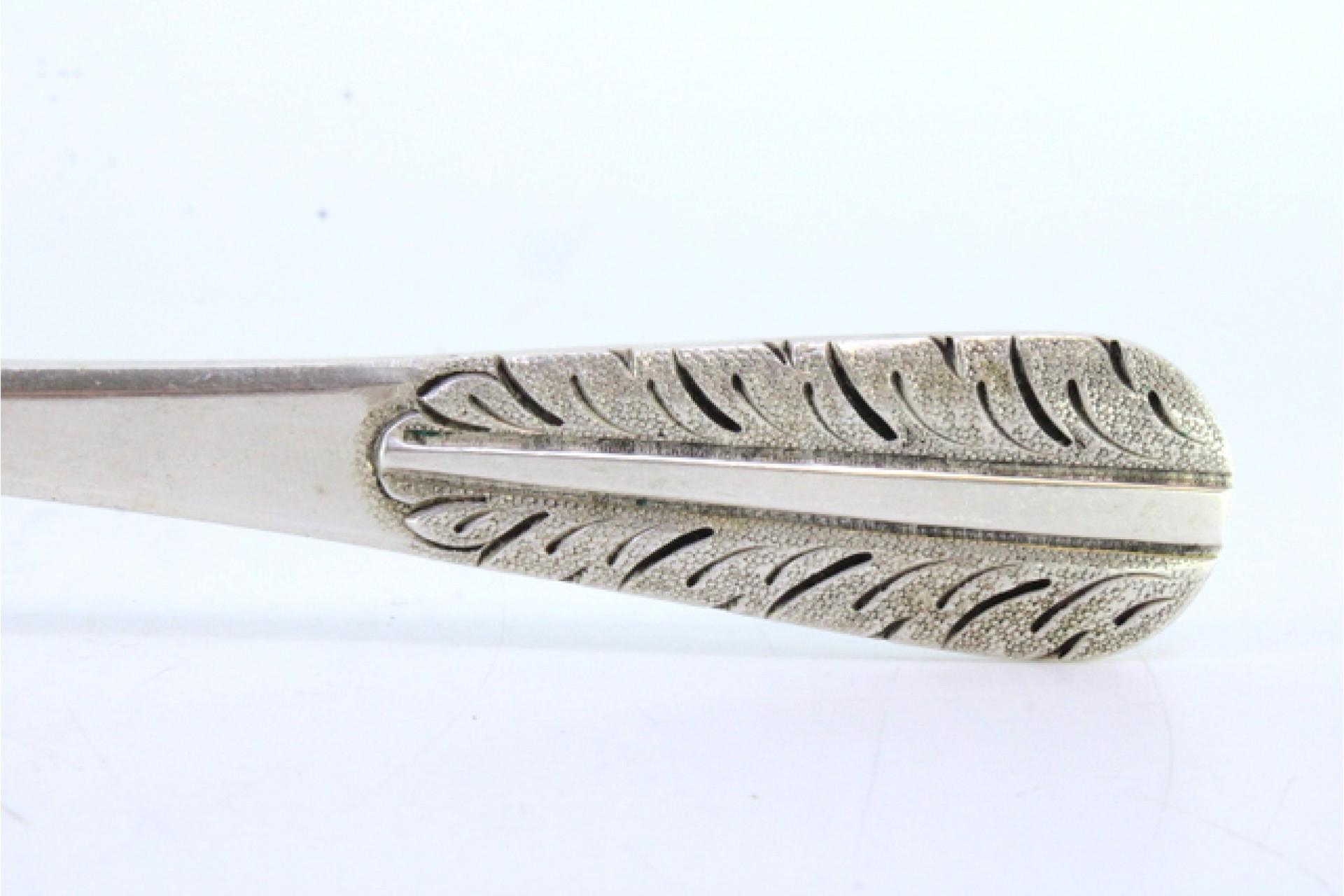 Descripción: Cuchara de servir y arrocera de plata con hojas de acanto grabadas en el mango. Metal: Silver. Origen: Portugués. Marca: Cabeça de escravo. Peso: 150,97 gramos. Dimensiones: 24,5 cm x 5 cm. Contenido: 833/1000. Marca de ensayo: Sí,