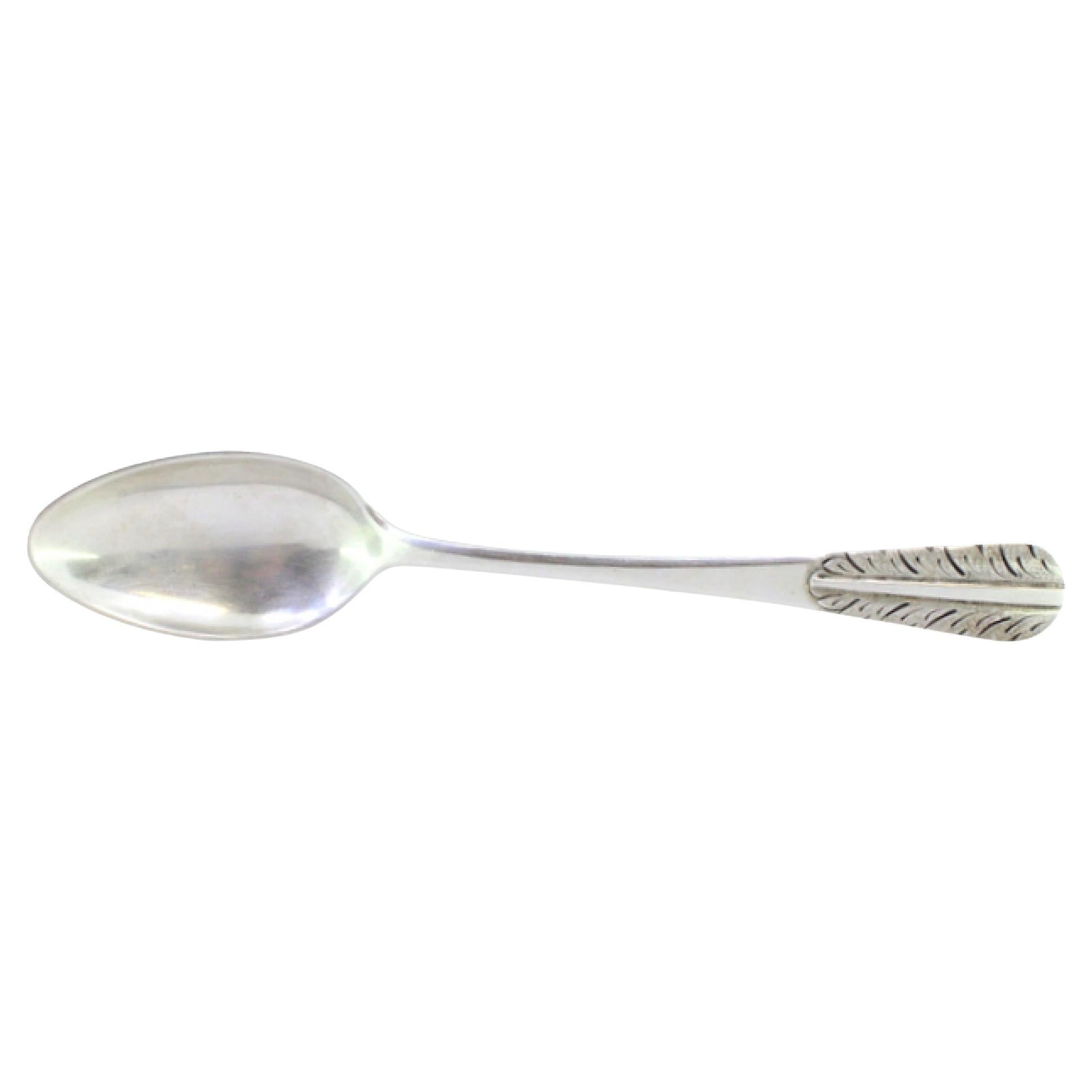 Silver rice and serving spoon with acanthus leaves embossed on the handle
