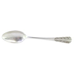 Silver rice and serving spoon with acanthus leaves embossed on the handle