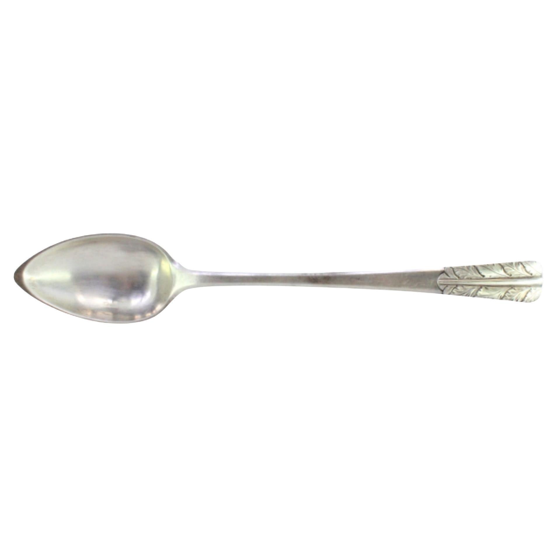 Silver rice and serving spoon with acanthus leaves embossed on the handle