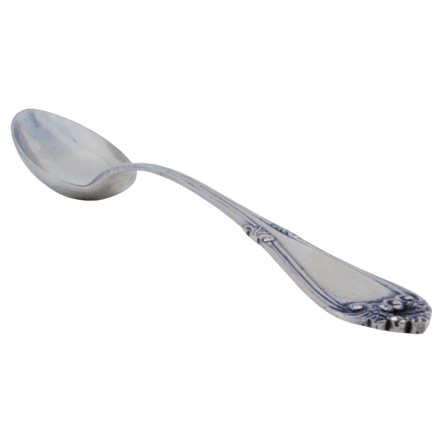 Silver rice and serving spoon with crimped, embossed handle and monogram card
