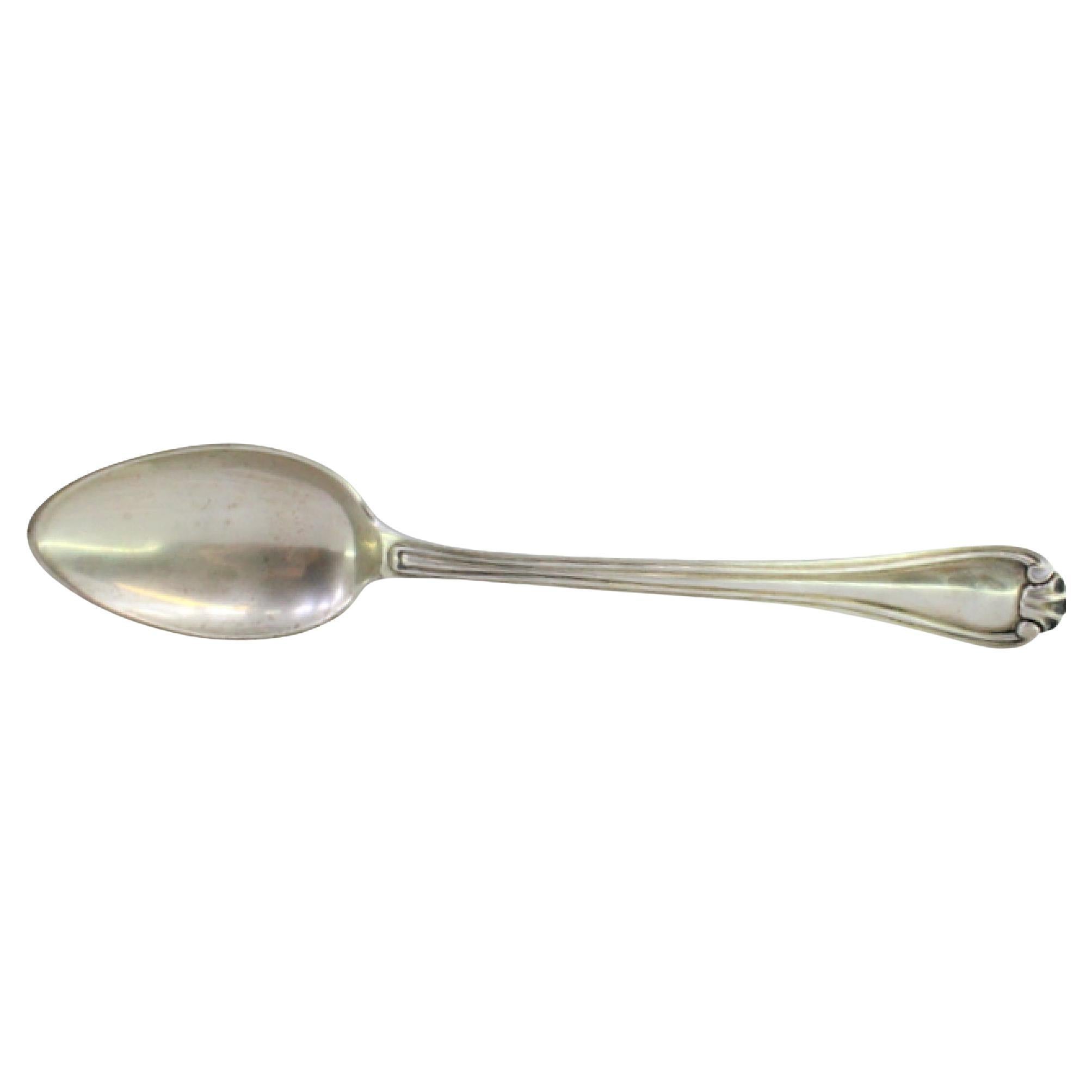 Silver rice and serving spoon with embossed trim along the handle