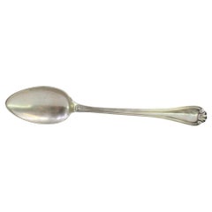 Silver rice and serving spoon with embossed trim along the handle