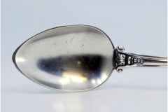 Silver rice and serving spoon with friezes and a raised shell on the handle