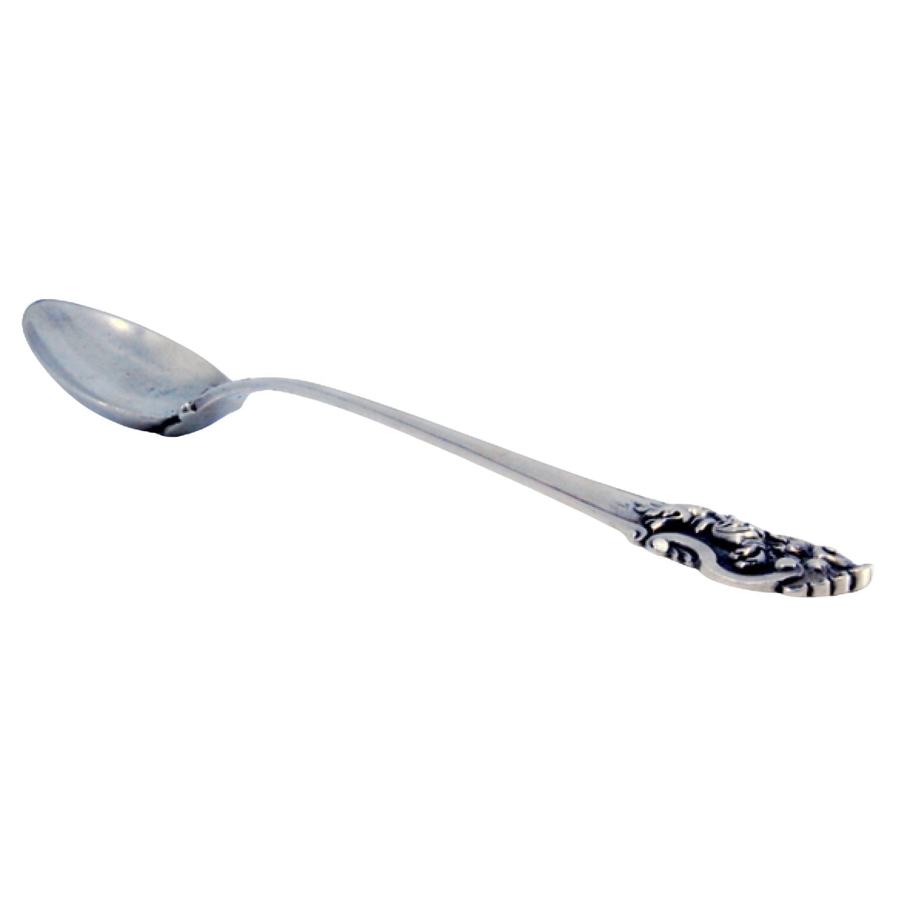 Silver rice and serving spoon with friezes and a raised shell on the handle