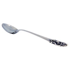 Silver rice and serving spoon with friezes and a raised shell on the handle