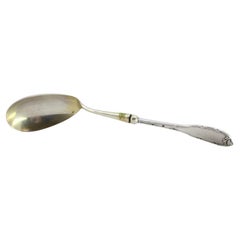 Silver rice and serving spoon with grooves and reliefs on the handle