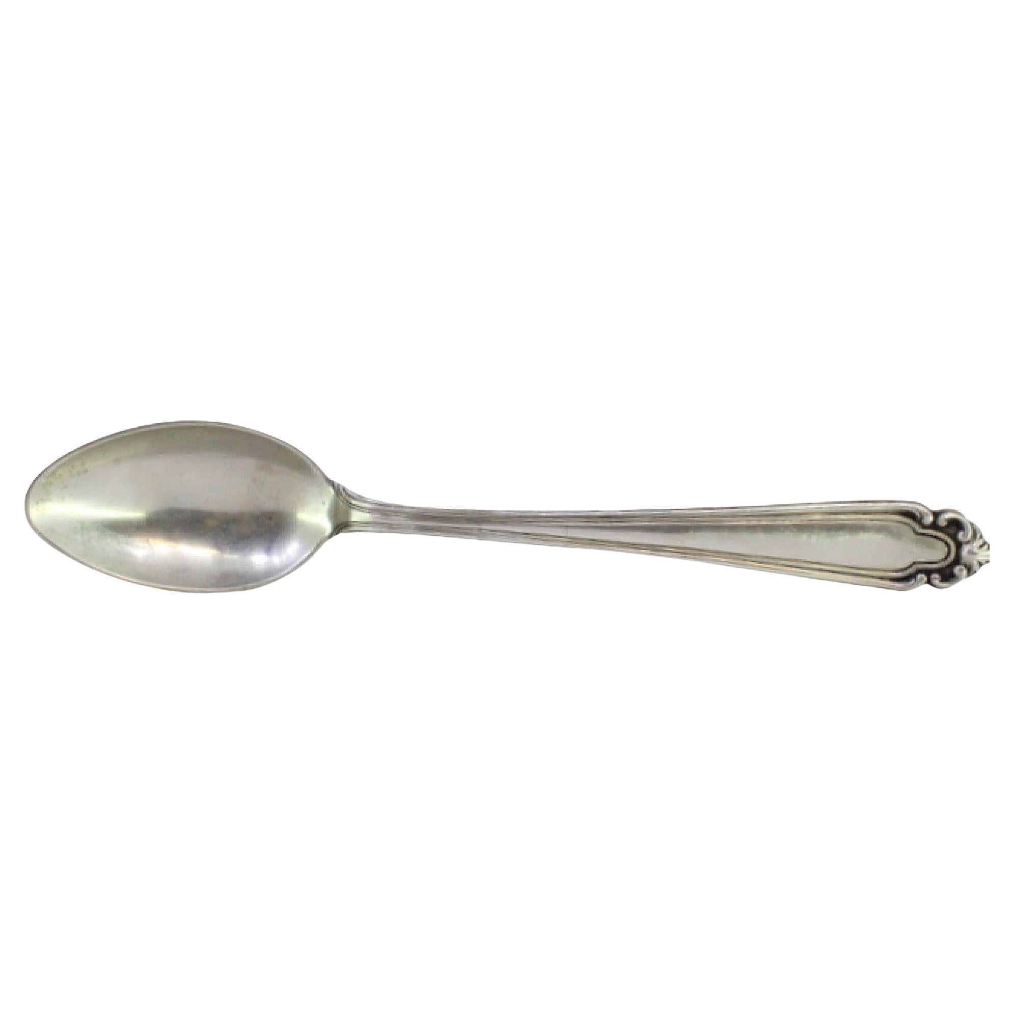Silver rice and serving spoon with grooves and reliefs on the handle