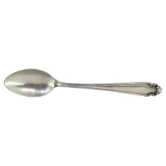 Silver rice and serving spoon with grooves and reliefs on the handle