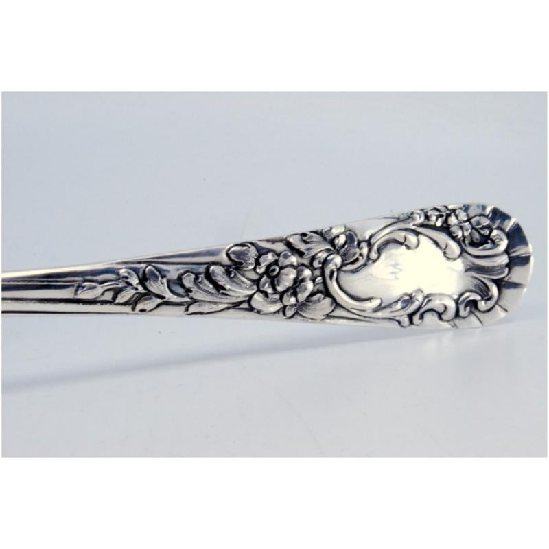 Silver rice and serving spoon with reliefs and a medallion on the handle siglo XIX en venta