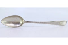 Silver rice and serving spoon with reliefs and grooves on the handle