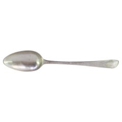 Silver rice and serving spoon with reliefs and grooves on the handle