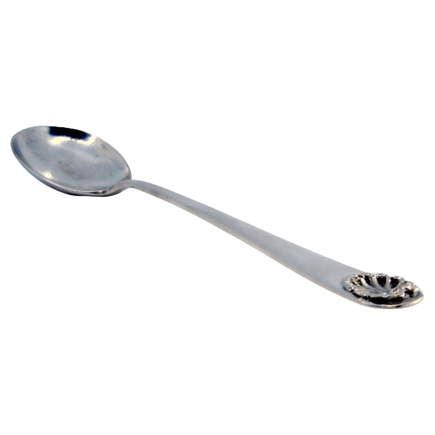 Silver rice and serving spoon with shell shape on the handle