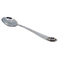 Silver rice and serving spoon with shell shape on the handle