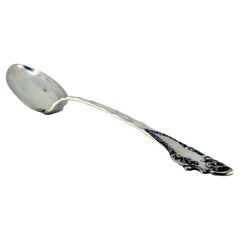 Silver rice and serving spoon with wavy handle and monogram card