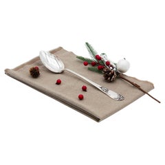 Silver rice and serving spoons with relief handles around monogram