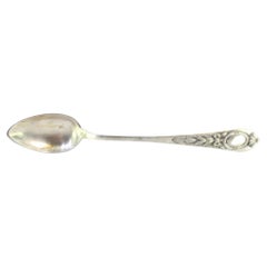 Silver rice 
serving spoon w/ floral reliefs on the handle 
a monogram card