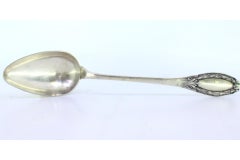 Silver rice & serving spoon w/ reliefs on the handle surrounding a monogram card