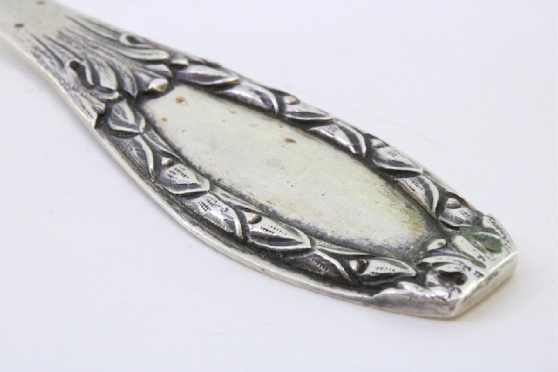 Silver rice & serving spoon w/ reliefs on the handle surrounding a monogram card Europeo en venta