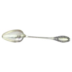 Silver rice
serving spoon w/ reliefs on the handle surrounding a monogram card