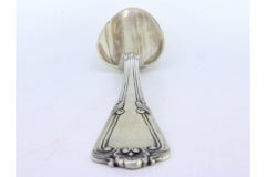 Silver rice & serving spoon w/ shell-shaped reliefs & friezes along the handle