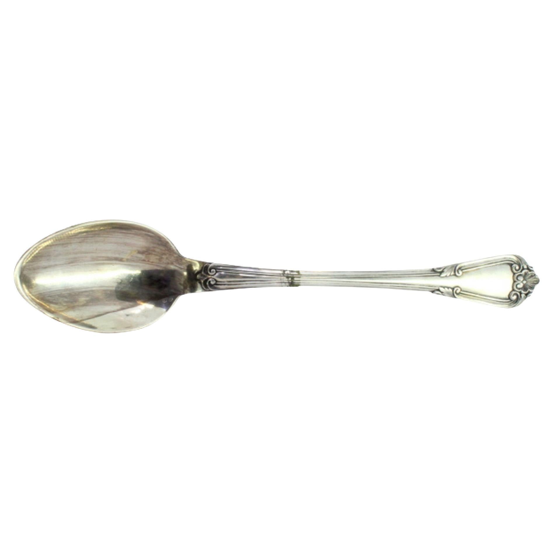 Silver rice
serving spoon w/ shell-shaped reliefs
friezes along the handle