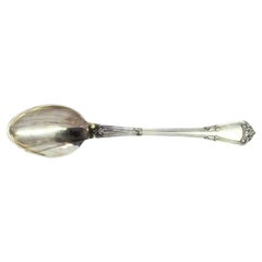 Silver rice 
serving spoon w/ shell-shaped reliefs 
friezes along the handle