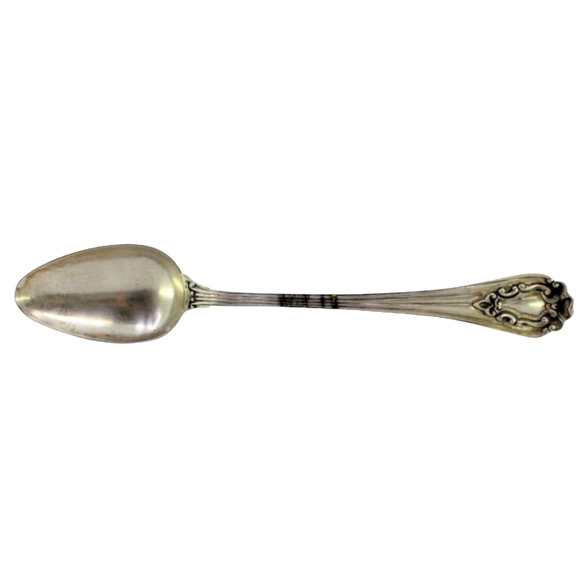 Silver rice/serving spoon with raised-edge handle and monogram plate