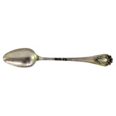Silver rice/serving spoon with raised-edge handle and monogram plate