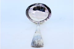 Silver rice/serving spoon with relief friezes, shell and scrolls