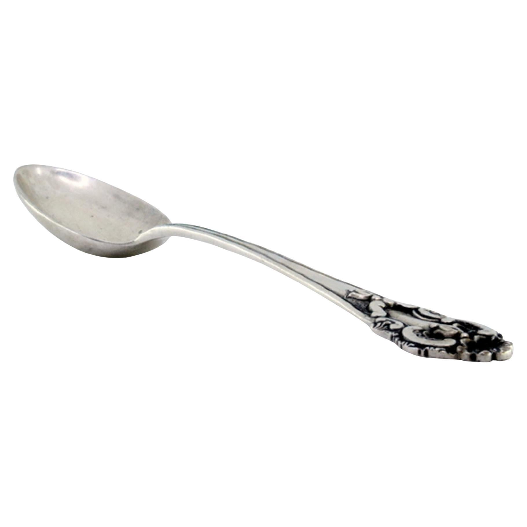 Silver rice/serving spoon with relief friezes, shell and scrolls