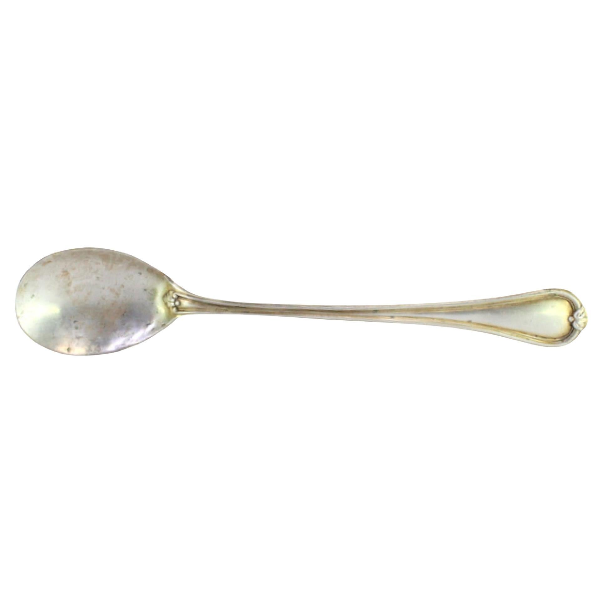Silver rice/serving spoon with strips on handle around monogram plate