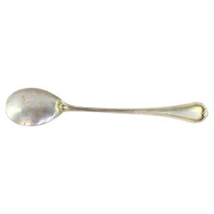 Silver rice/serving spoon with strips on handle around monogram plate