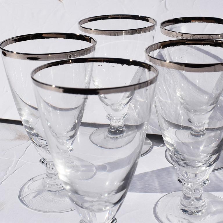 Set of 8 delicate stemware set. The glasses in this set could be used for a number of cocktails. We love the idea of an Arnould Palmer. But that's just us. The rims of these beauties are painted in a metallic silver. Cups have a round top rim and