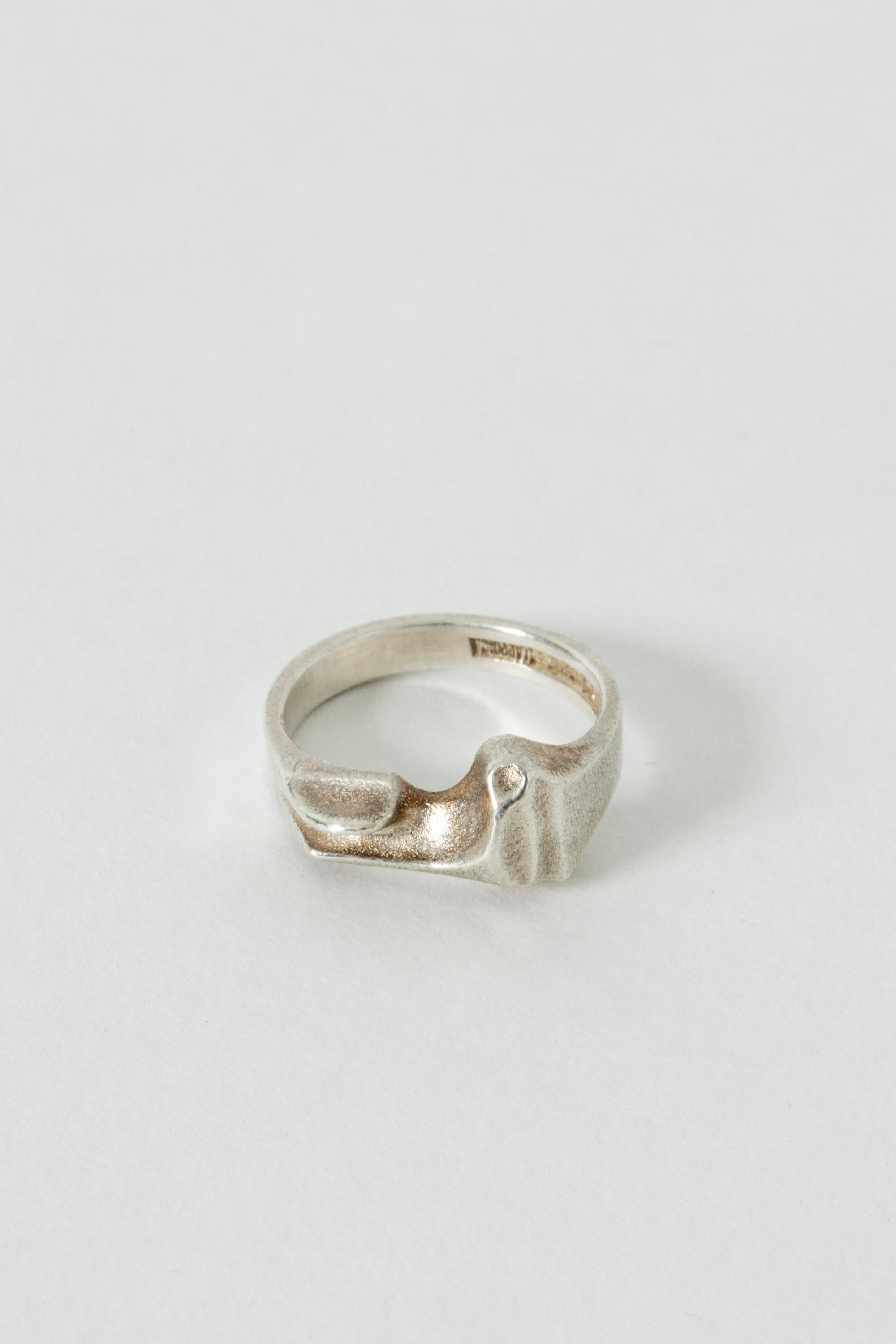 Silver ring by Björn Weckström, model called “Pluto”. Discreet, yet expressive with its organic design. Brushed surface.