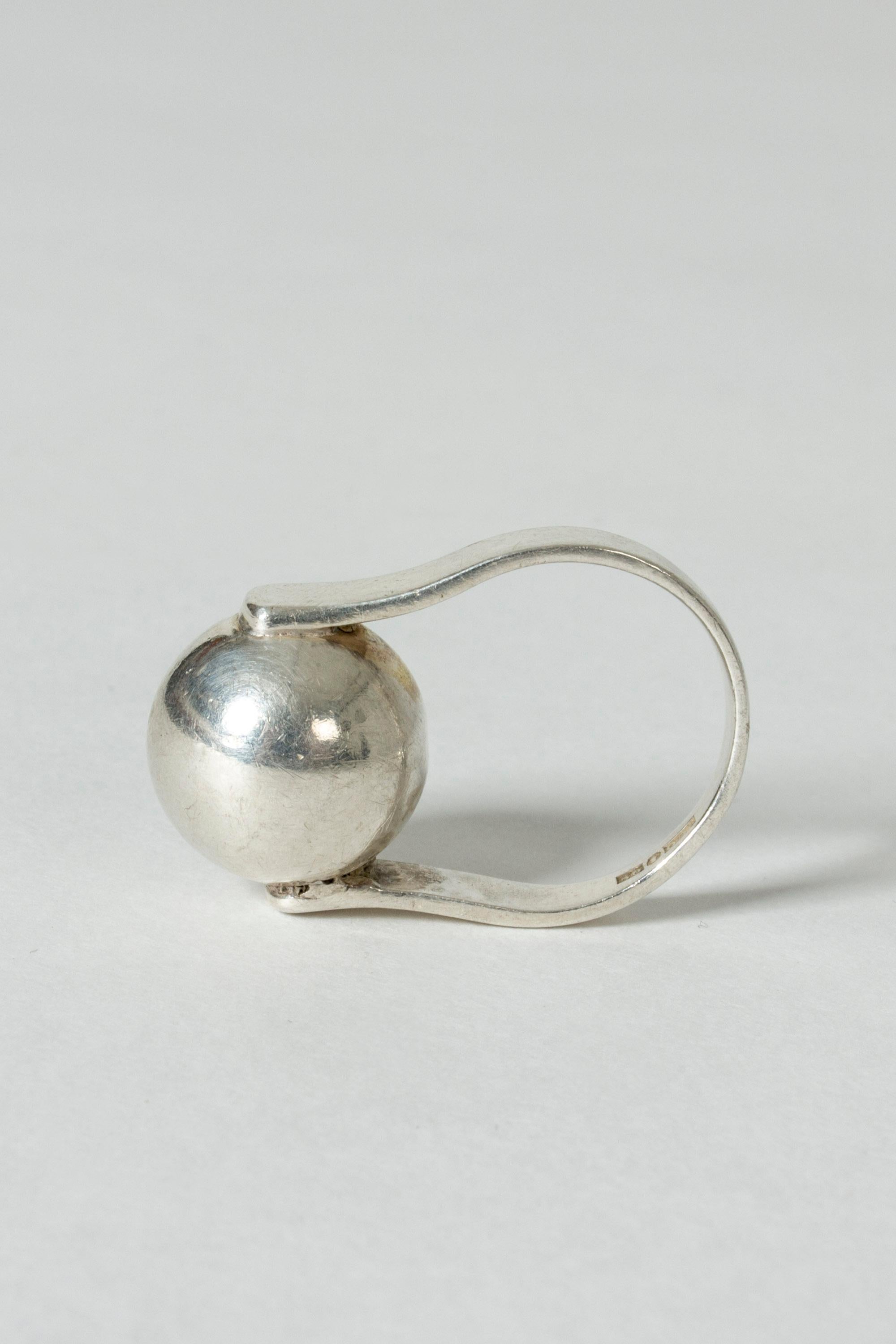 Silver ring by Isaac Cohen with a large silver sphere, elegantly held up by the silver band.