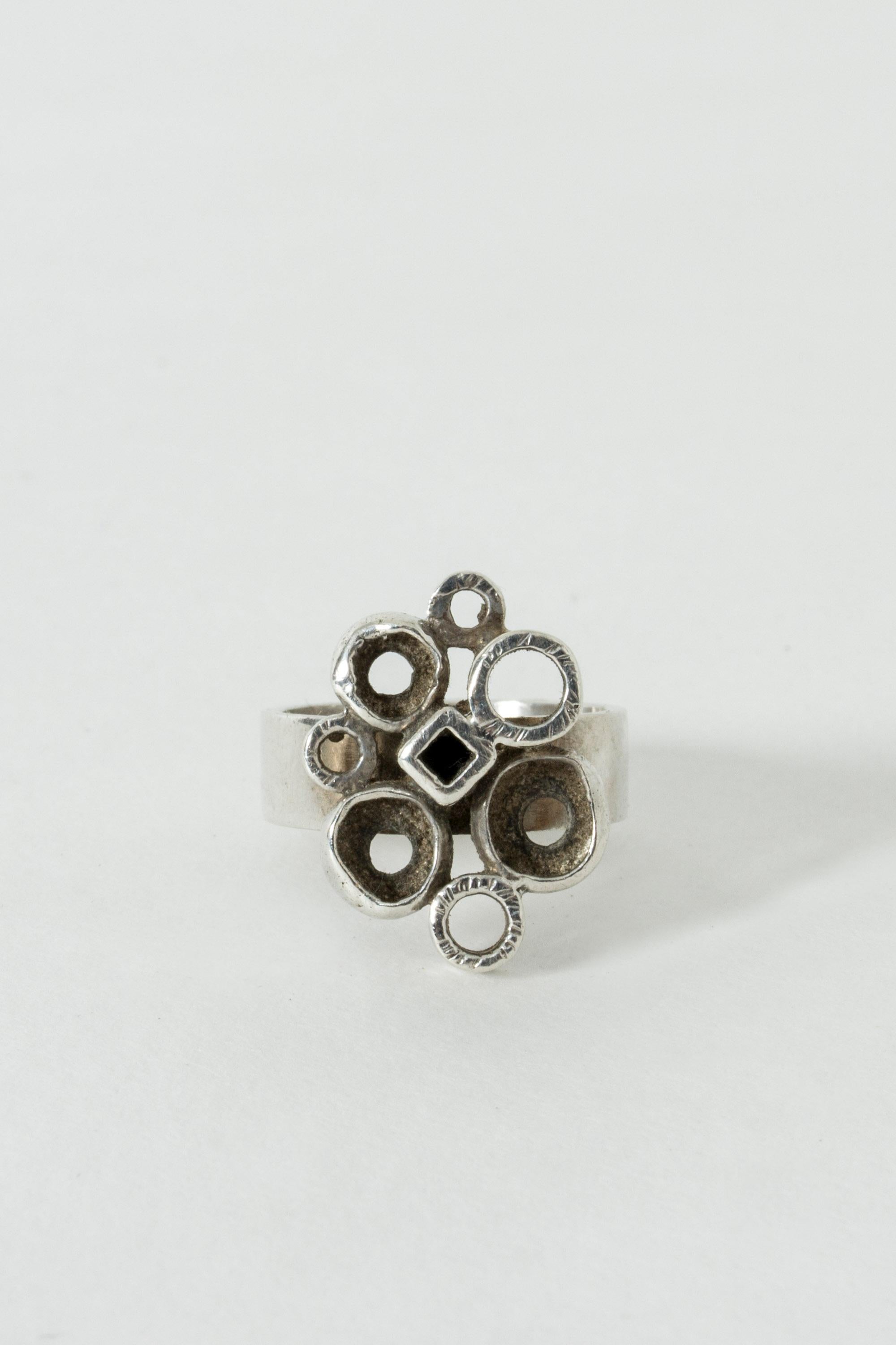Cool silver ring by Isaac Cohen, adorned with a cluster of spheres and a cube. The different sizes and levels of the forms create an interesting, dynamic effect.