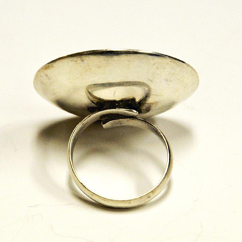 Unique, cool, rare and vintage!  Indeed a very special midcentury silver ring with a big red plate. A ring that catch the eye. Decorative for parties, cool for everyday use as well. The ring is marked 925. Probably from the 1970s with unknown
