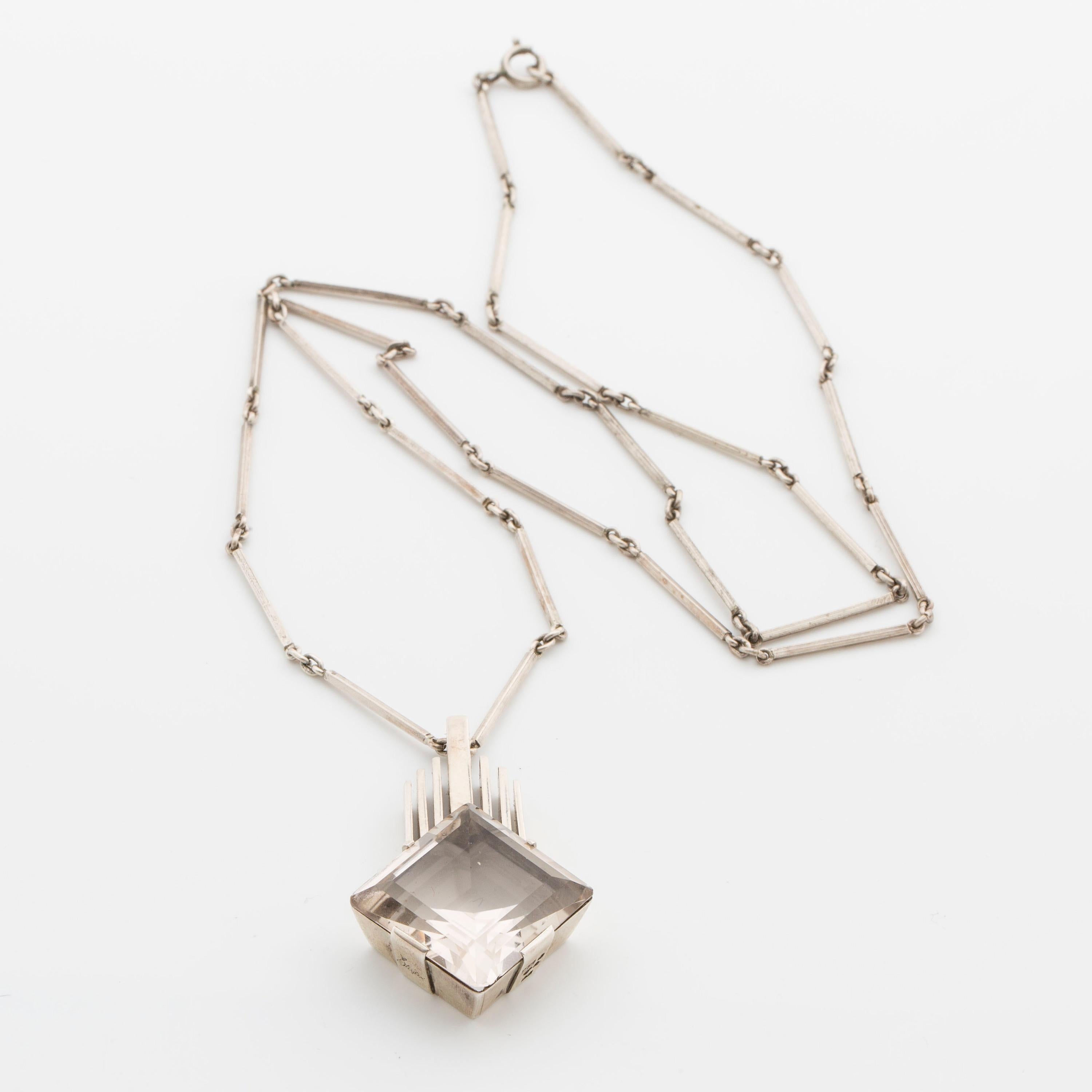 Wonderful, classic and art deco silver pendant with a crystal rock. Designed and made in Stockholm by Stigbert ca 1945. 

Pendant with height 4,5 cm. Chain with length ca 66 cm. Weight 26 gram.