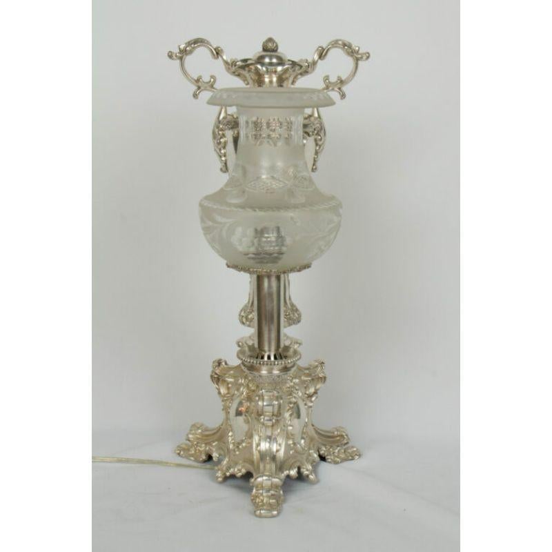 Silver argand lamp from the mid-19th century. Rococo Revival with very ornate and beautiful casting. Bronze with original silver plate. Completely restored, polished, and rewired. Shade has a small chip in rim, as photographed. 

Dimensions: