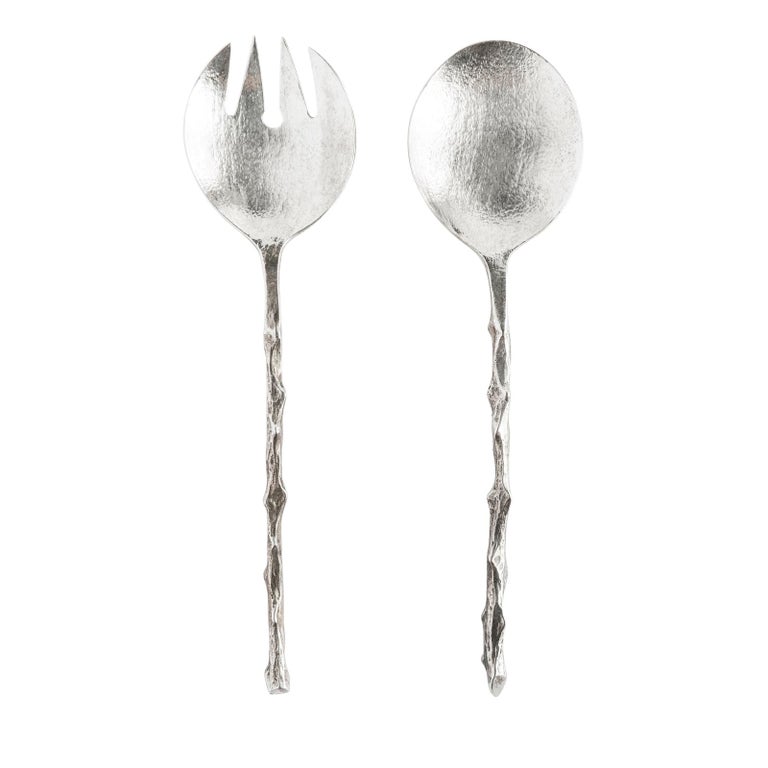 Exquisite set of a sterling silver spoon and fork, handmade by Osanna Visconti using the lost-wax casting technique. The two pieces feature a circular bowl for the spoon and four similarly-shaped symmetrical prongs for the for, but both are