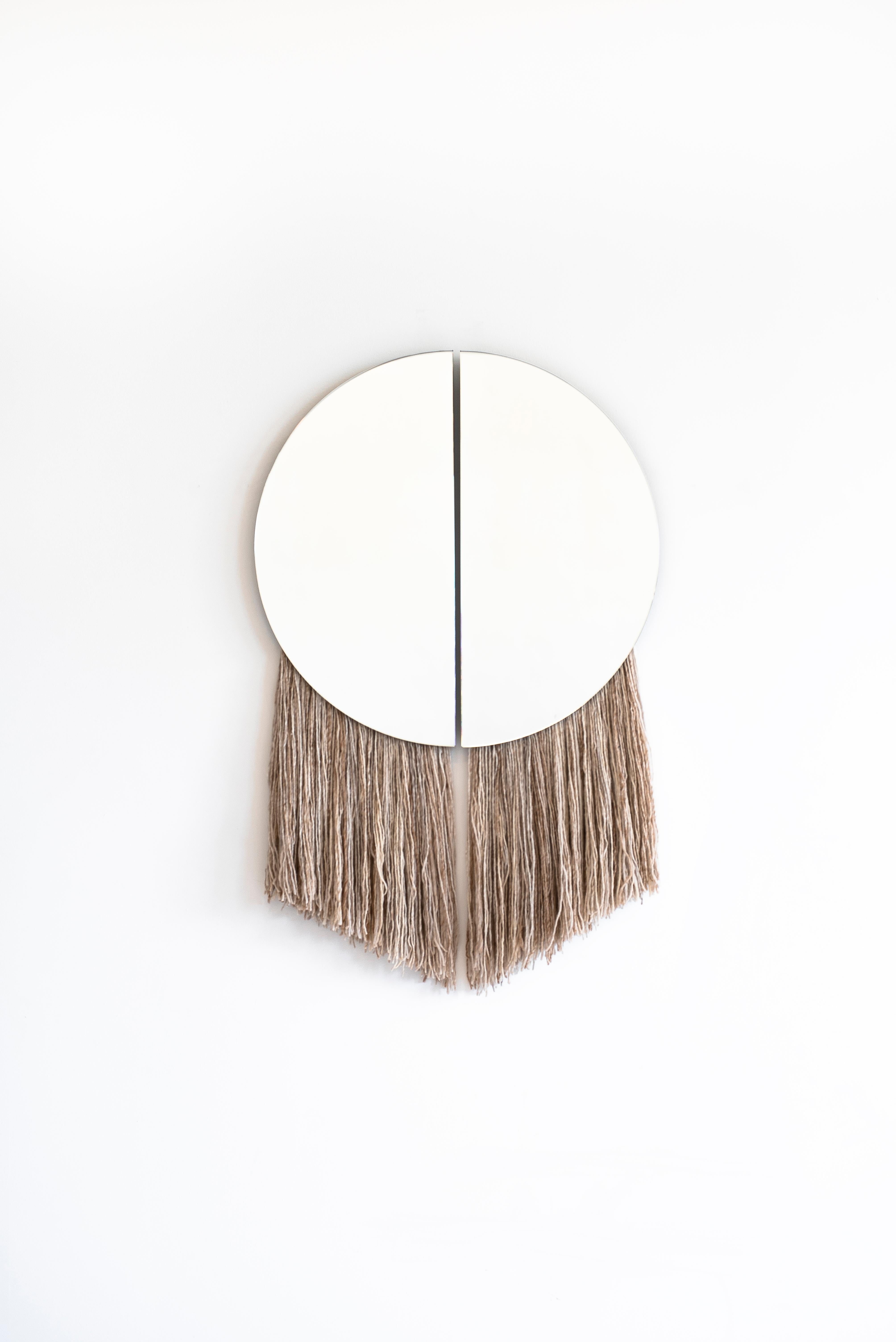 Named for the Greek God of the Sun, the Apollo Mirror is the marriage of sculptural and functional object, with two half circle mirrors joined by negative space and partnered with hand-spun, hand painted silk fiber.

Customization of mirror color,