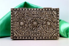 Silver safe-shaped box with floral motifs on four spherical feet