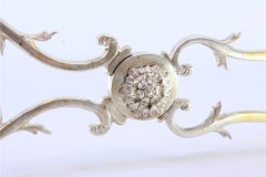 Silver salad, bread or sauce tongs with a gold-colored cutout shell