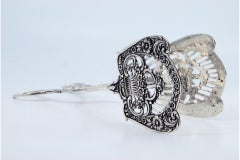 Silver salad or bread tongs with cutout shells and raised stems