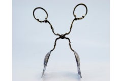 Silver salad or bread tongs with cutouts and intertwined stems