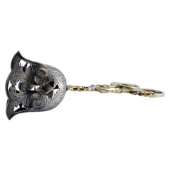 Silver salad or bread tongs with cutouts and intertwined stems