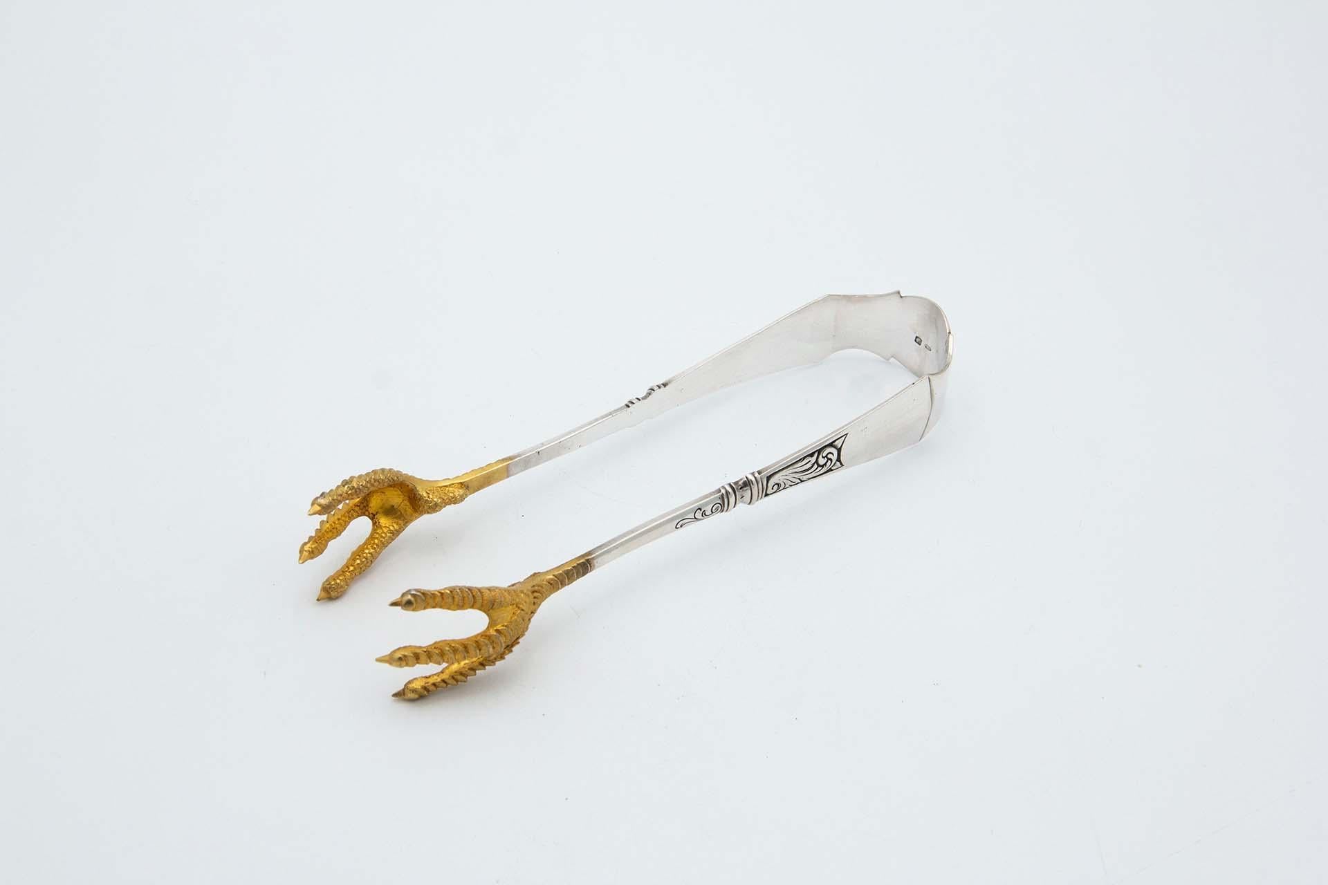Silver salad tongs with gold claws For Sale