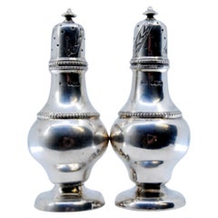 Silver salt and pepper shakers with pearls on the body and screw caps